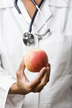 a nutritionist holding a nutritious apple